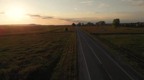Aerial shot: vehicles, trucks and cars driving by road.