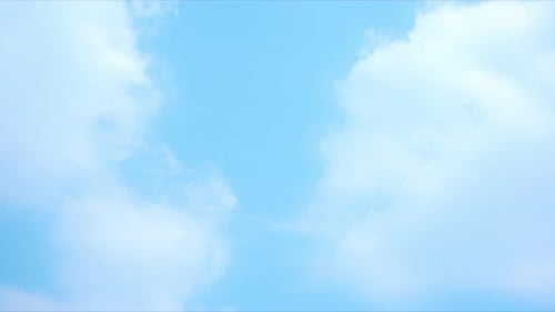 Light Clouds Moving Slowly in Vibrant Blue Sky