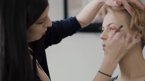 Woman Getting Makeup Applied by Makeup Artist