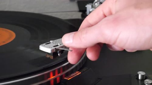 Hand Moves Needle on Vintage Record Player