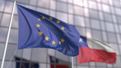 European Union Flag Waving in Front of Modern Building