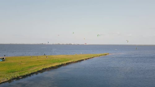 Flight Over the Sea Bay Where People Practice Kitesurfing in the Wind