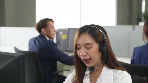 Call center young employee working with headset, Smiling customer support operator team