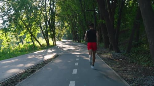 Slow Motion Man Jogging on Bike Lane