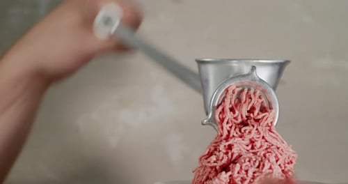 Men's Hands Prepare Raw Minced Meat on a Meat Grinder.