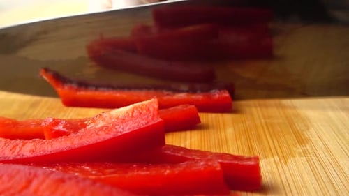 Slicing Red Bell Pepper into Strips with Knife