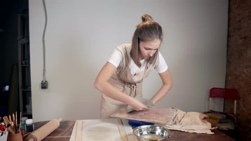Woman Shaping Clay in Pottery Studio