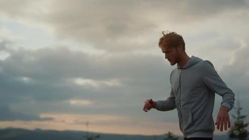 Male Jogger Warming Legs Before Workout
