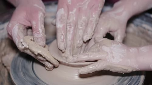 Hands Shaping Clay on Pottery Wheel Close Up