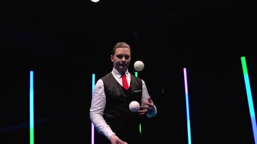 Circle Movement Kamera um professionellen Zirkuskünstler jongliert weiße Bälle gegen ein Schwarz