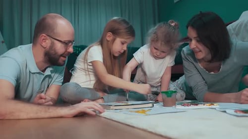 Family Drawing Together on Floor at Home