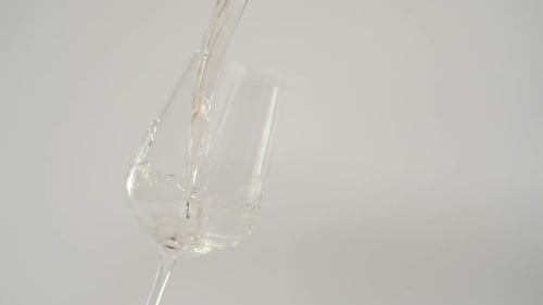 Slow Motion of Pouring White Wine in Tilted Glass at 1000 Fps