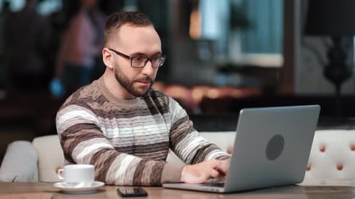 Focused Modern Man Working Remotely Use Laptop Pc at Cafe