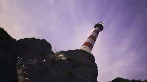 Lighthouse light spinning around. Tall tower standing on the small island.