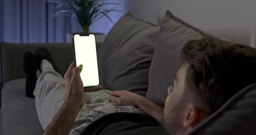 Man Using Smart Phone With Green Screen Relaxing