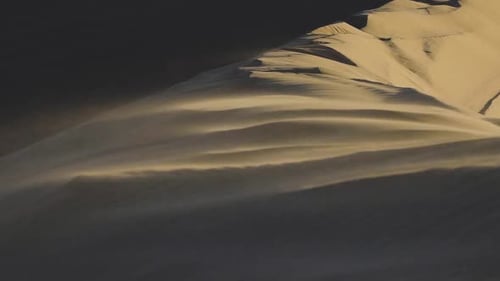 Nahaufnahme von Sand, der in Zeitlupe auf einer riesigen Sanddüne in der Little Sahara Nation im Wind weht