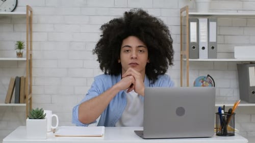 Young Adult Working at a Desk with Laptop