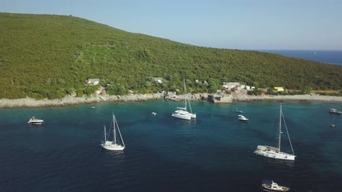 Aerial view of group of Yachts cruising on the sea or ocean in summer day in Montenegro.
