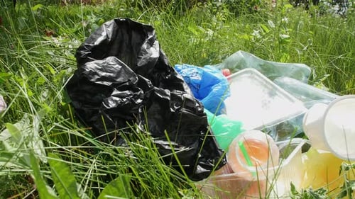 Plastic Waste Littering Green Grassy Field