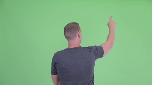 Rückansicht eines jungen Mannes mit dem Finger