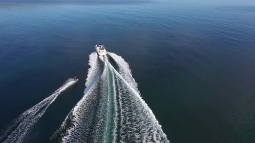 Speedboat with wakeboard rider into the sea
