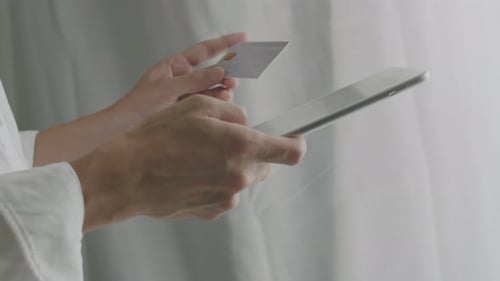 Close-up businessman using tablet purchase online shopping and use a credit card payment.