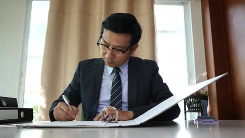 Man in Suit Stamping Documents in Office