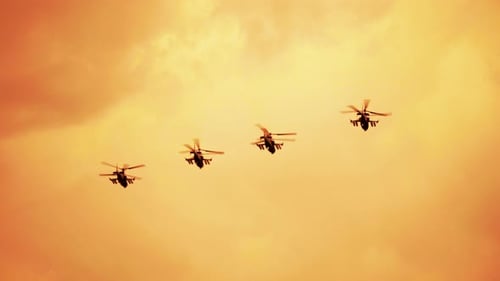 Helicopters Flying in Formation at Sunset