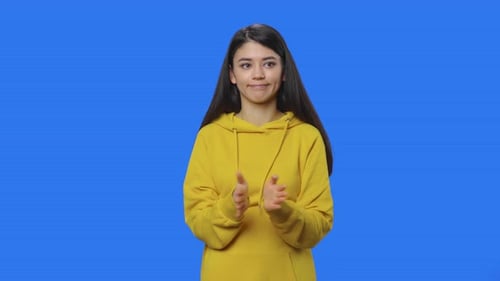 Woman with Expressions and Arms Crossed on Blue Background
