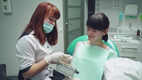 Dentist and patient in dentist office. Dental clinic.