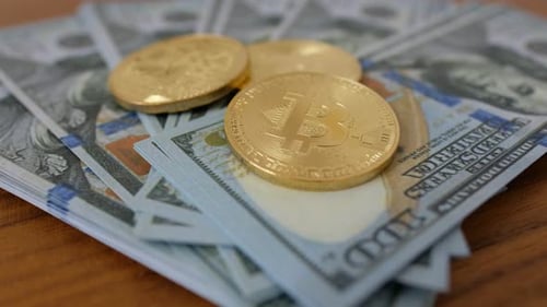 Gold Bitcoin Coin BTC Rotate, Twist, Swirling, Spinning and Falls on the Table with Dollars. Slow