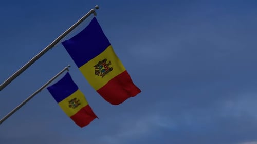 Two Moldova National Flags Waving Against Blue Sky