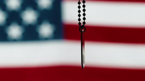 Dog Tag Rotating Against American Flag Backdrop