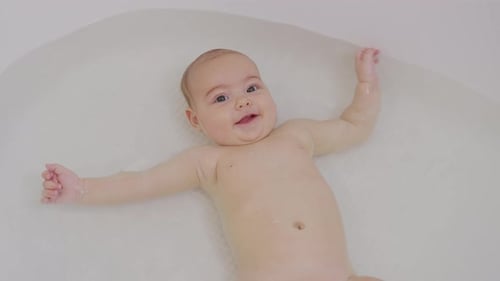 Top View of Funny Newborn Baby Swimming During Bathing.