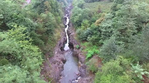 Flight Over the Rocky Canyon and Stream
