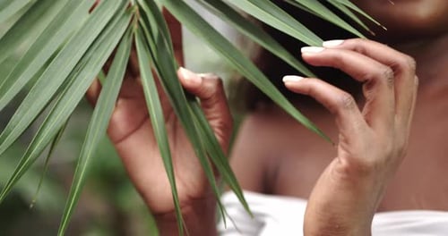 Smiling Woman Posing with Tropical Palm Leaf