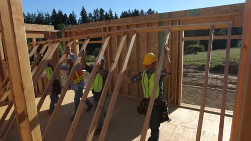 Construction Workers Building a Wooden Wall