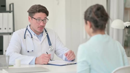 Doctor Consults With Patient in Medical Office