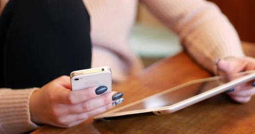Woman using digital tablet and mobile phone