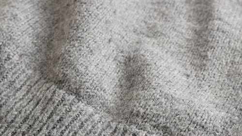 Tilting on modern gray women sweater knitting high quality texture close-up 4K 2160p 30fps UltraHD