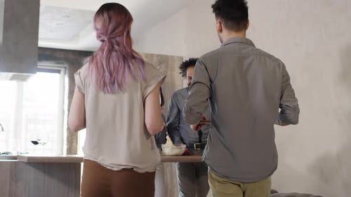 Friends Preparing Food and Wine in Kitchen