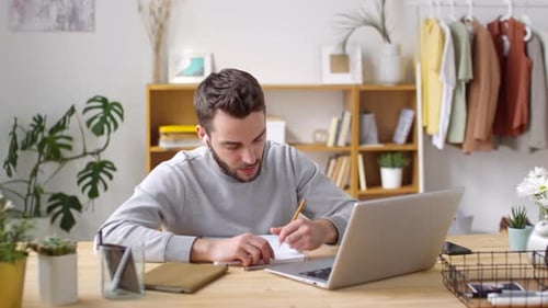 Man Talking on Video Call while Working Remotely from Home