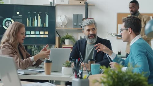 Multiethnic Team of Office Workers Discussing Business Working Talking at Desk in Board Room