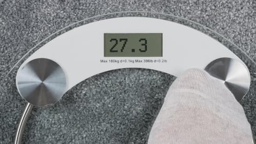 Feet on Scale Displaying Weight and Sad Face