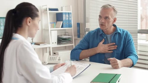 Man Describes Symptoms to Doctor in Office