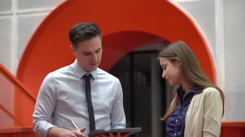 Business people discussing while walking in the office.