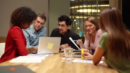 Young Professionals Collaborating on Project in Office