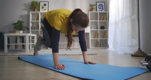 Young Adult Woman Exercising Doing Mountain Climber Workout
