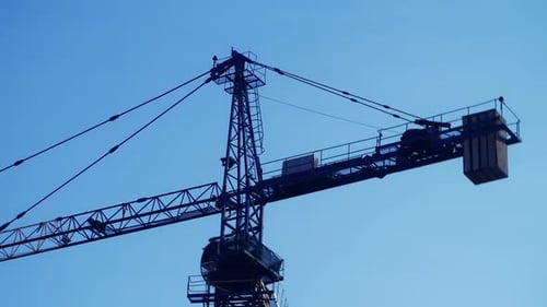 Blue Construction Crane Against Blue Clear Sky