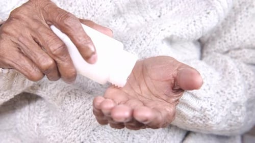 Close Up of Medical Pills on Senior Women's Hand